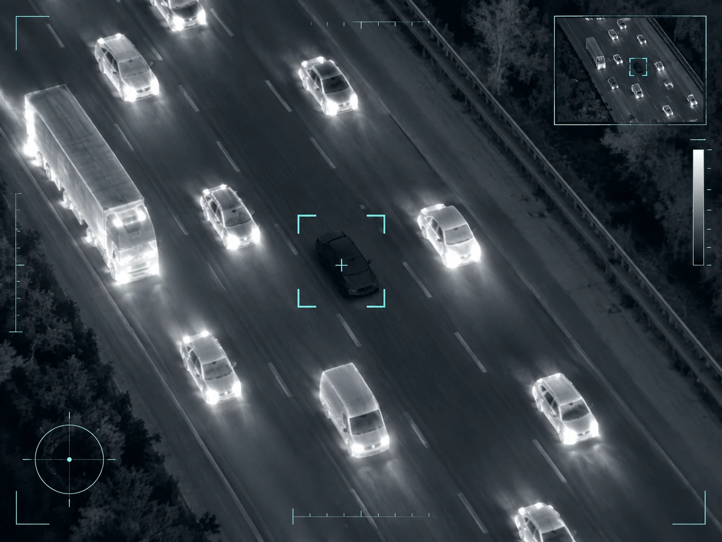 Thermal aerial view of highway traffic isolating a low-signature vehicle